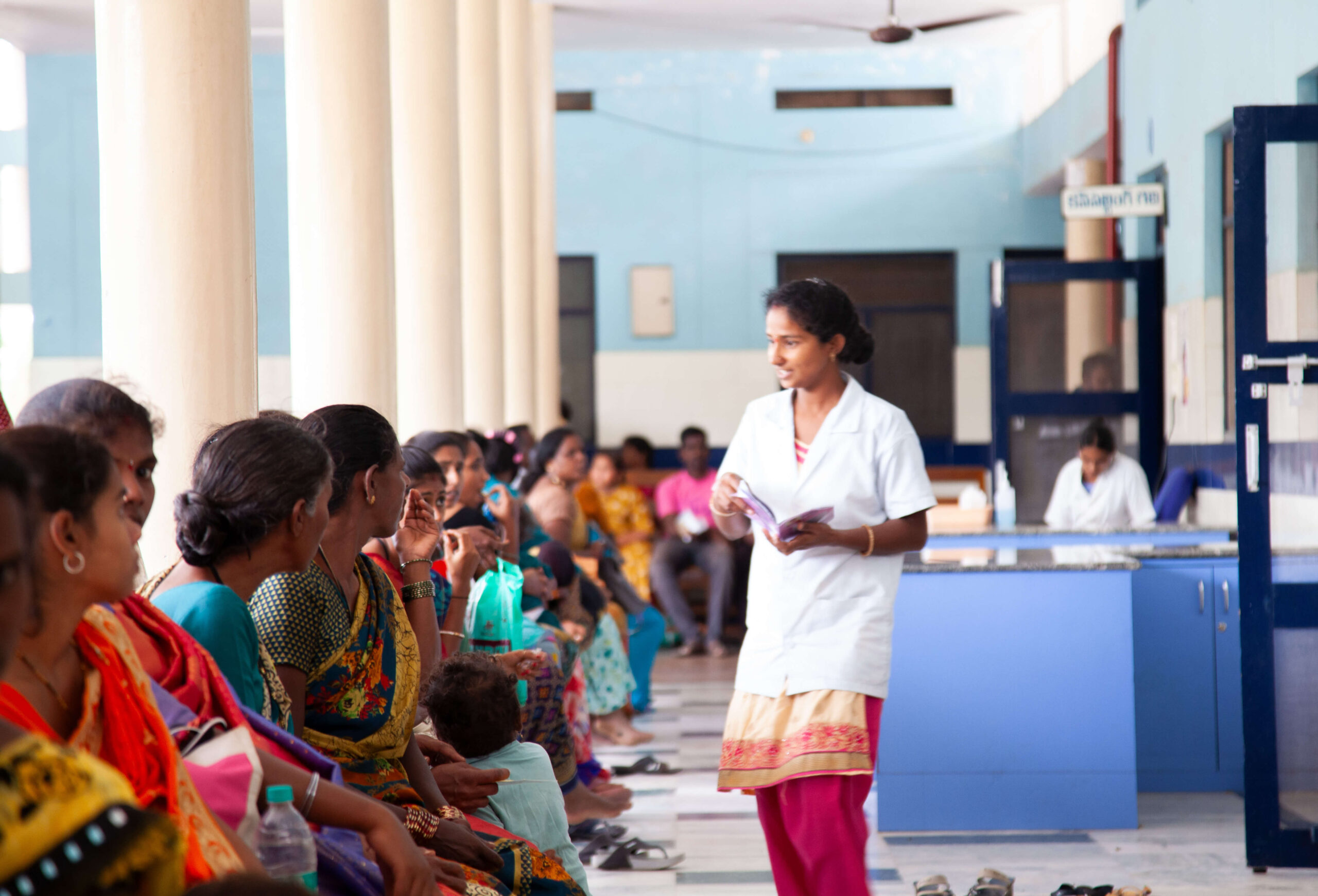 A nurse is talking to a group of people at Kalyandurg Hospital.